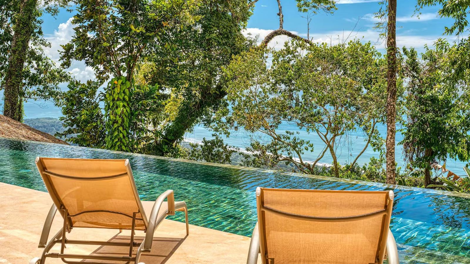 the ocean through the trees from the pool deck