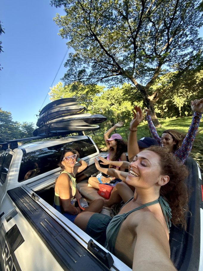 the group heading to the beach with the boards