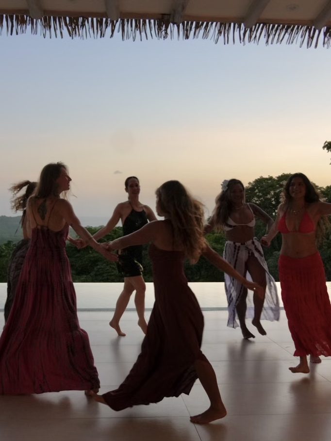 dancing in a circle as the sun goes down